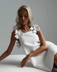 Elegant White Mini Dress with Floral Shoulder Detail.